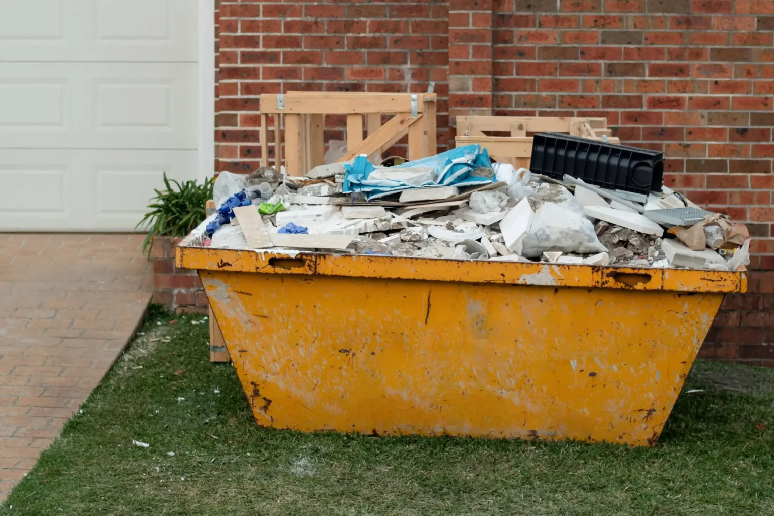 Full skip containing insulation, wood, and mixed debris, highlighting efficient skip hire Dorset from Dorset Skips.