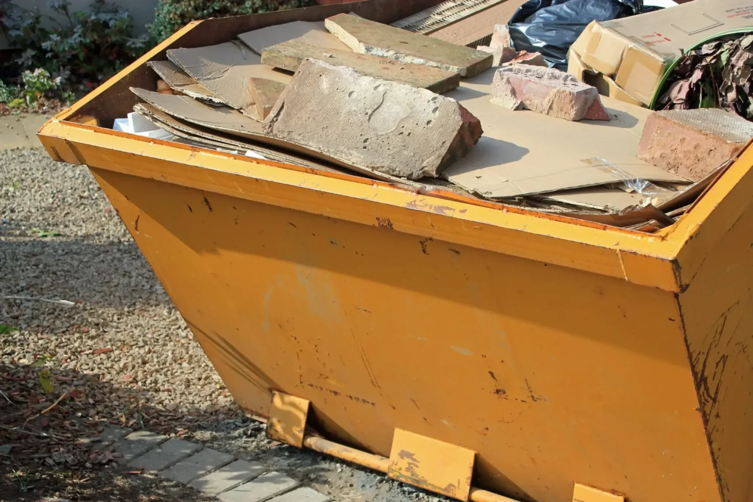 Heavy rubble and renovation materials piled in a skip, highlighting Dorset Skips as a trusted skip hire Dorset provider